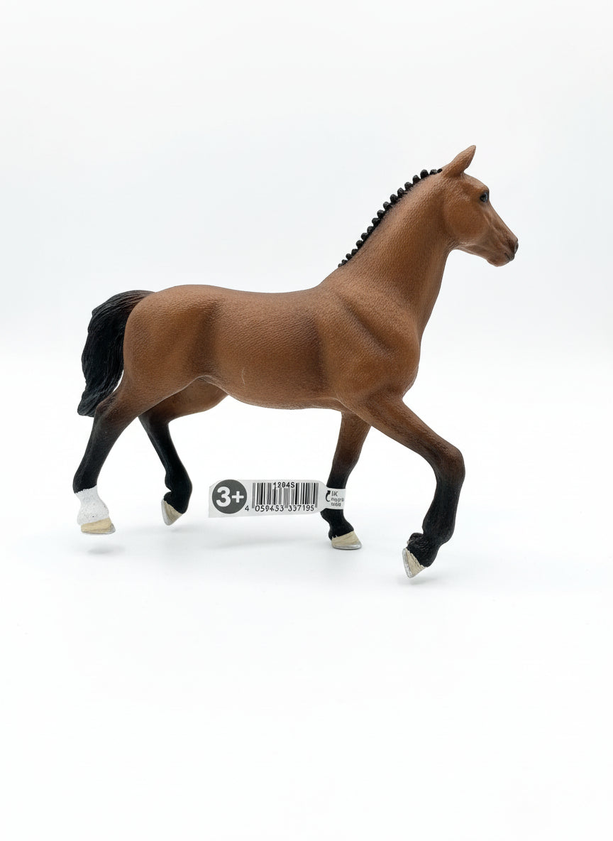 Brown horse figurine with a label on a light wooden floor