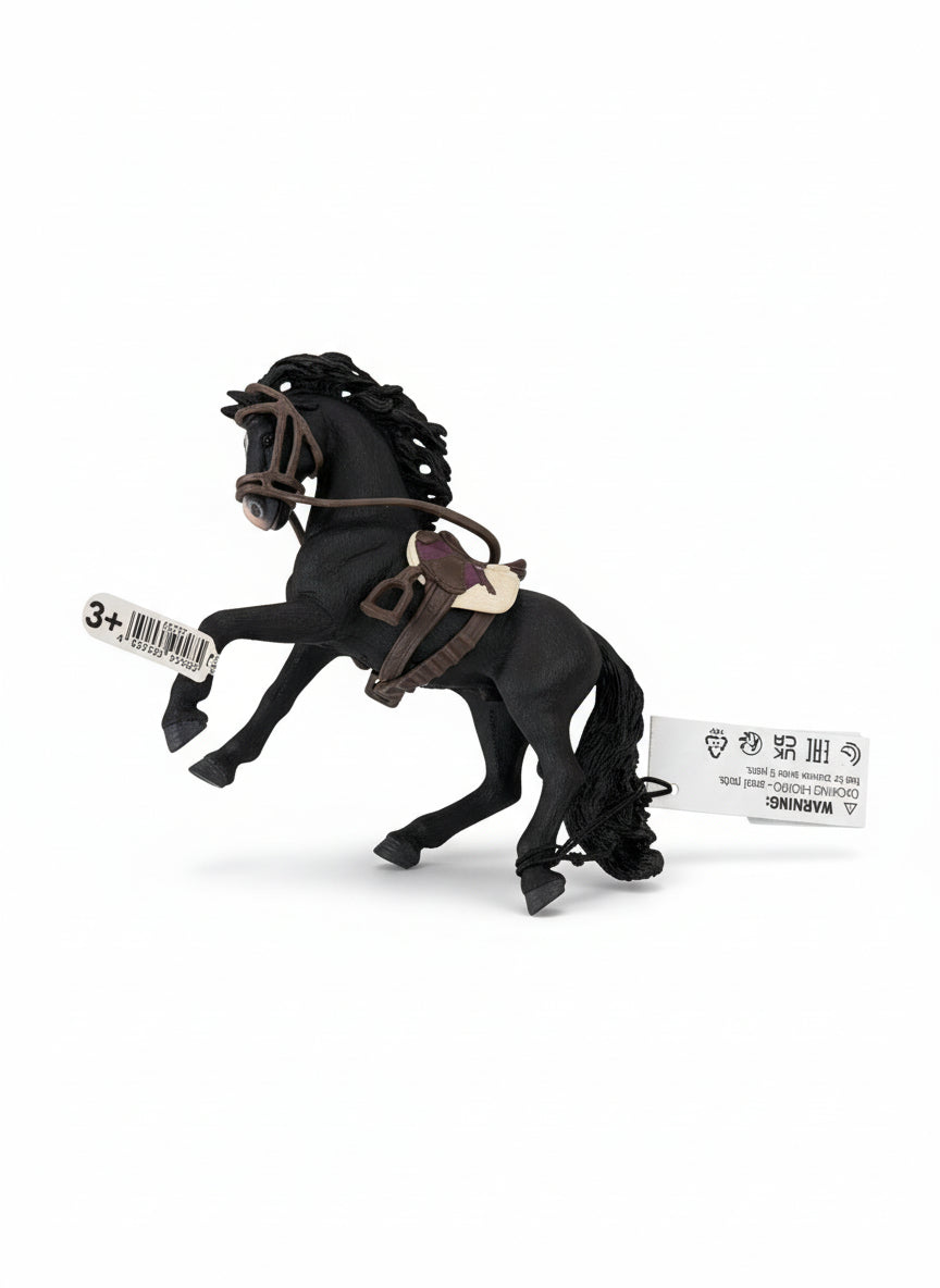 Black horse figurine with a bridle on a light wooden floor