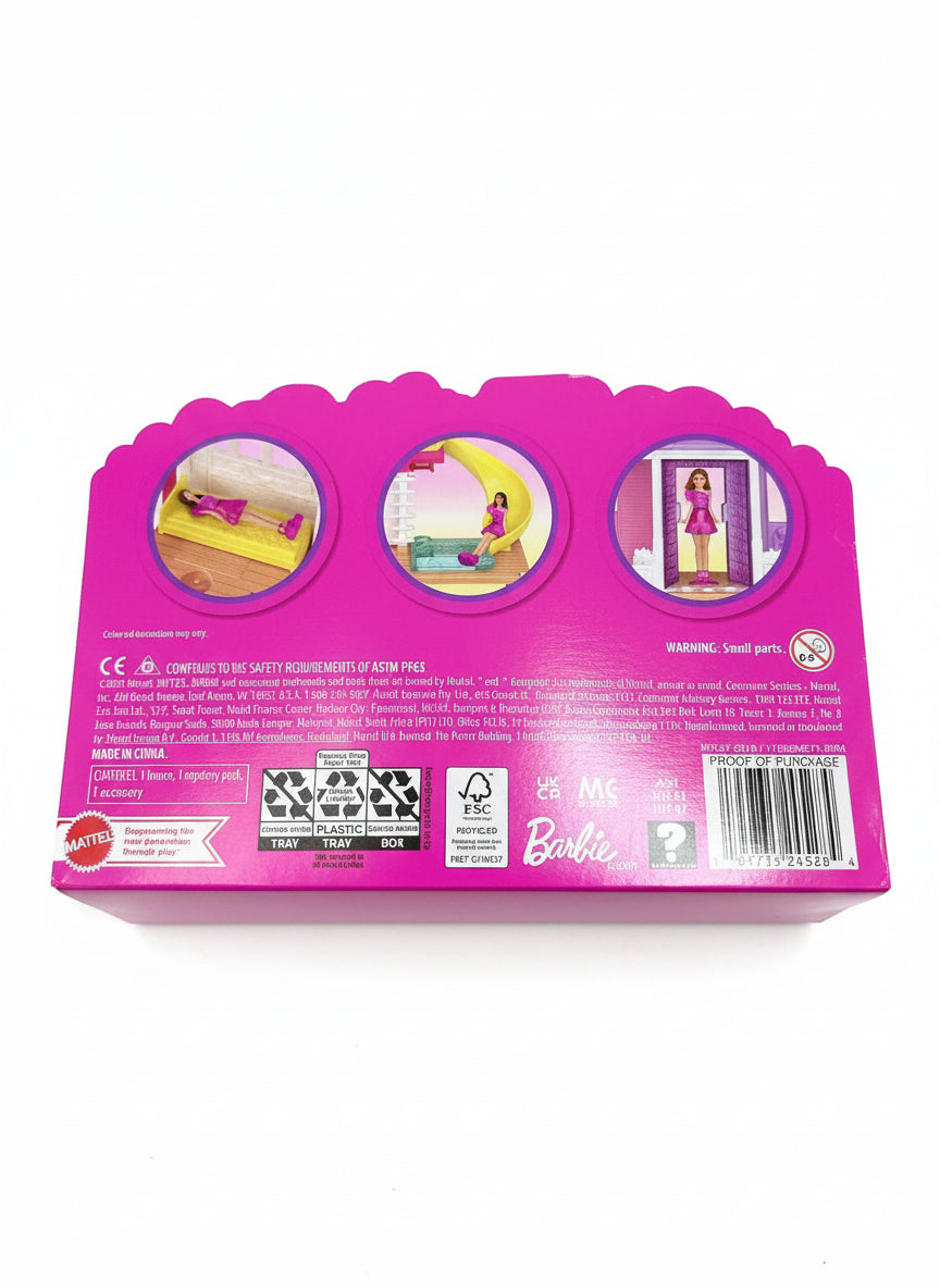 Pink toy packaging with images of dolls and furniture on a wooden floor.
