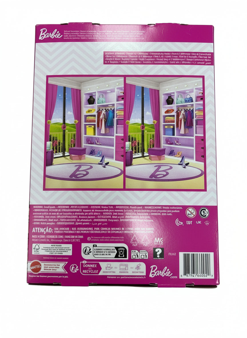 Barbie playset packaging with a wardrobe and furniture on a wooden surface