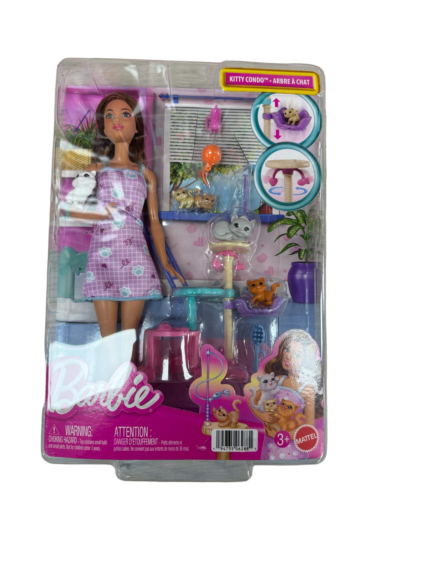 Barbie doll in packaging with accessories on a wooden surface