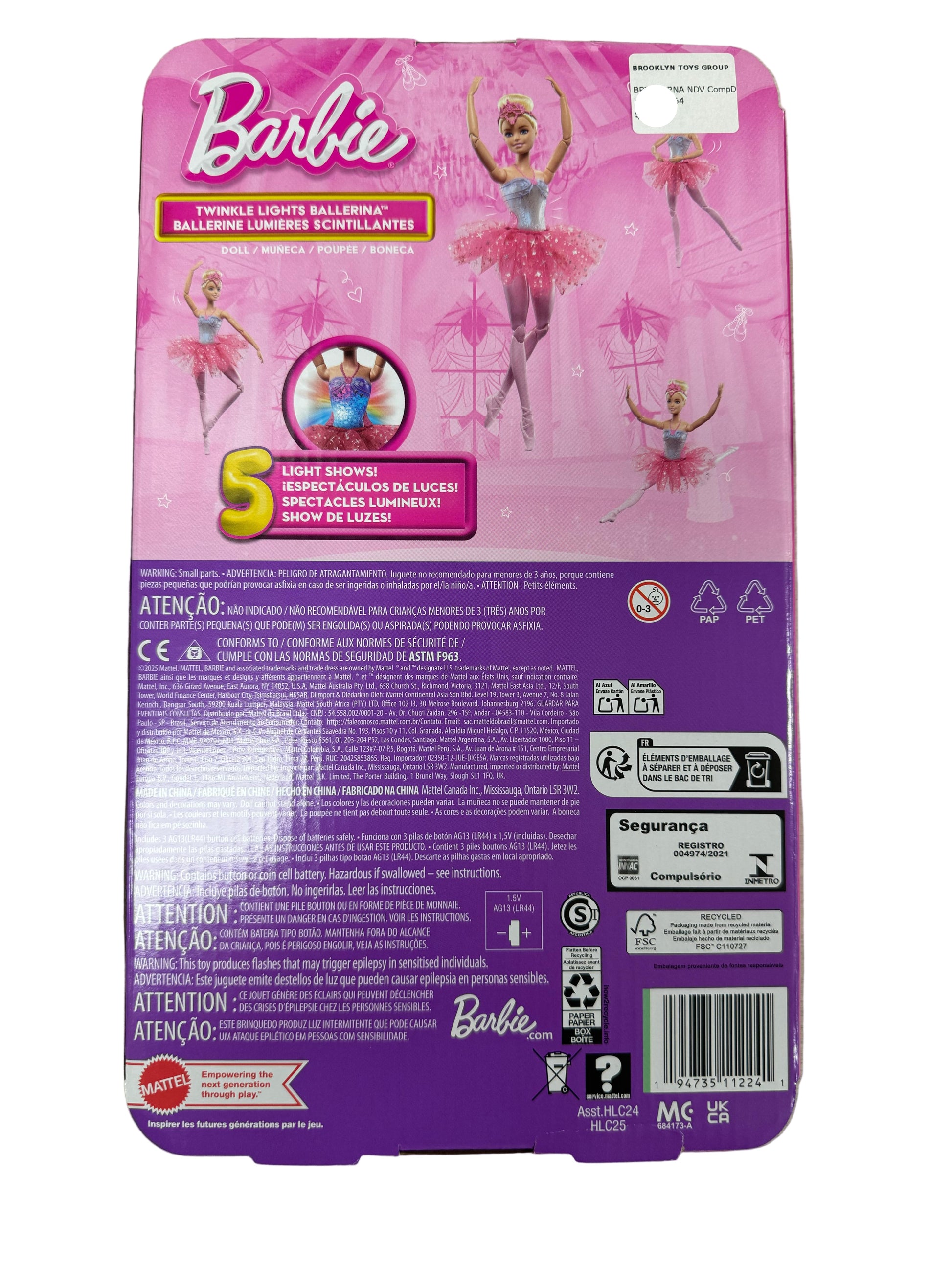 Barbie doll packaging with pink and purple design on a wooden surface