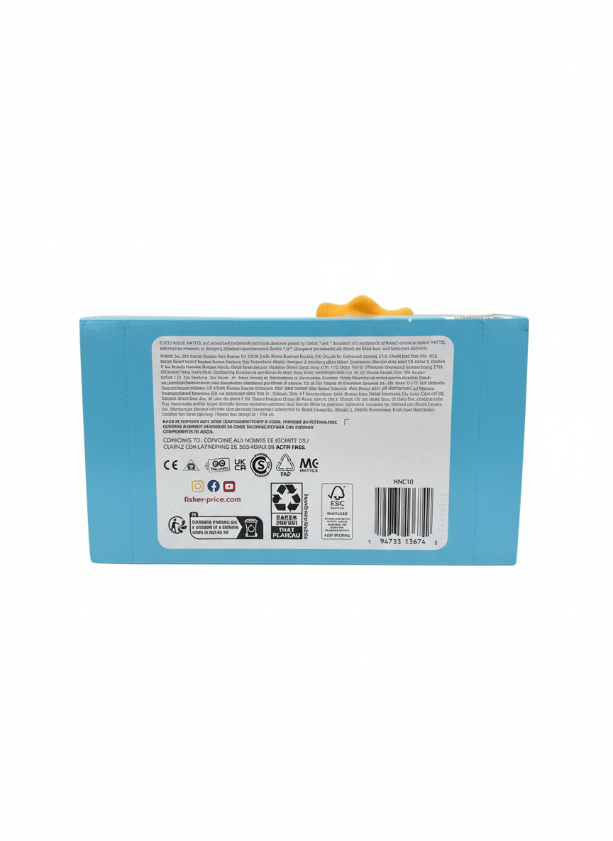 Blue box with a label on a gray surface, with colorful wrapping paper in the background.