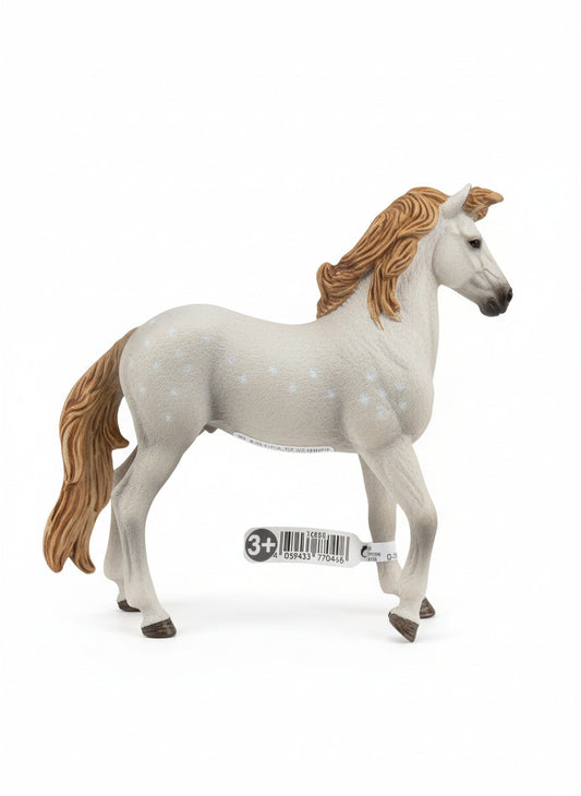 Horse figurine with a label on a wooden floor