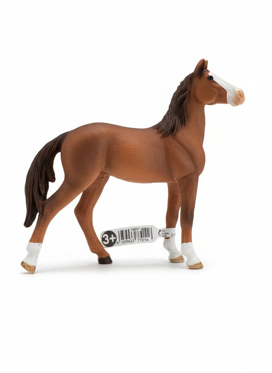 Brown horse figurine with white feet on a gray surface