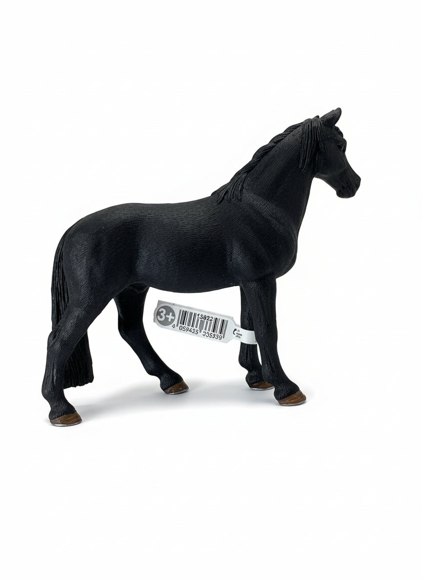 Black horse figurine with a visible barcode on a light wooden surface