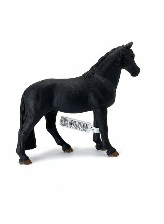 Black horse figurine with a visible barcode on a light wooden surface