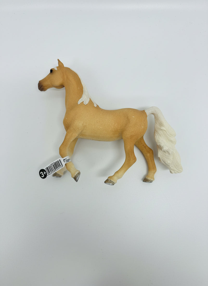 Toy horse with a tag on a wooden floor