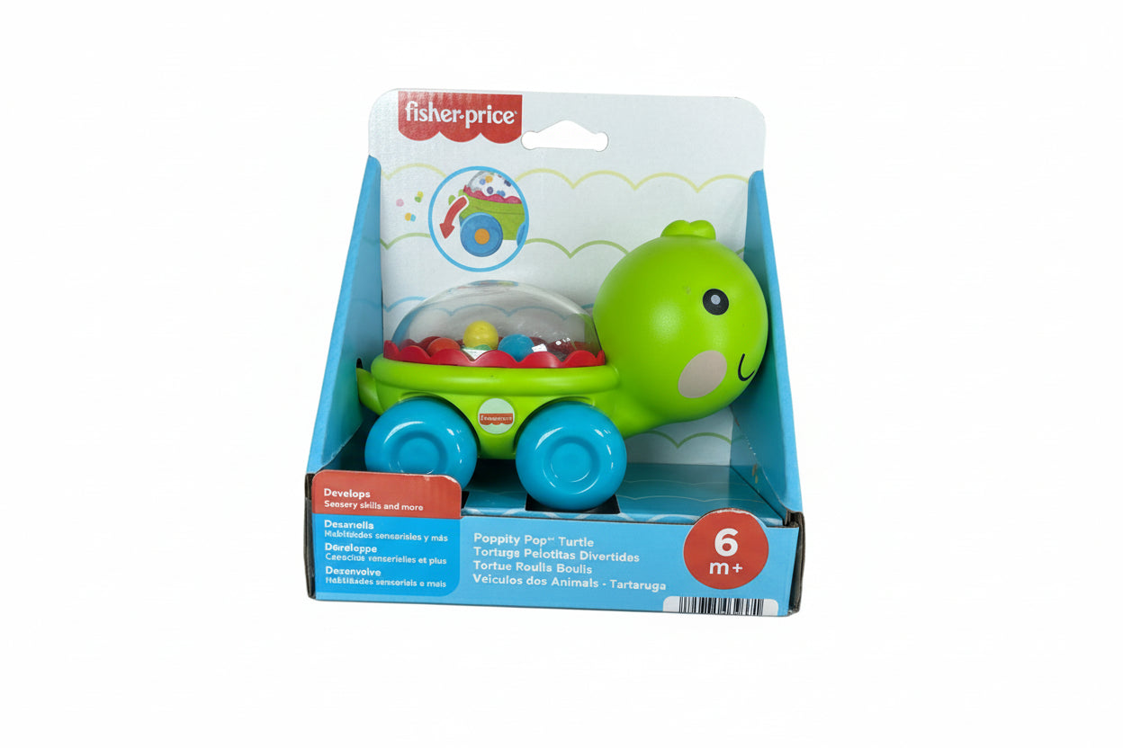 Fisher-Price toy turtle in packaging on a wooden surface
