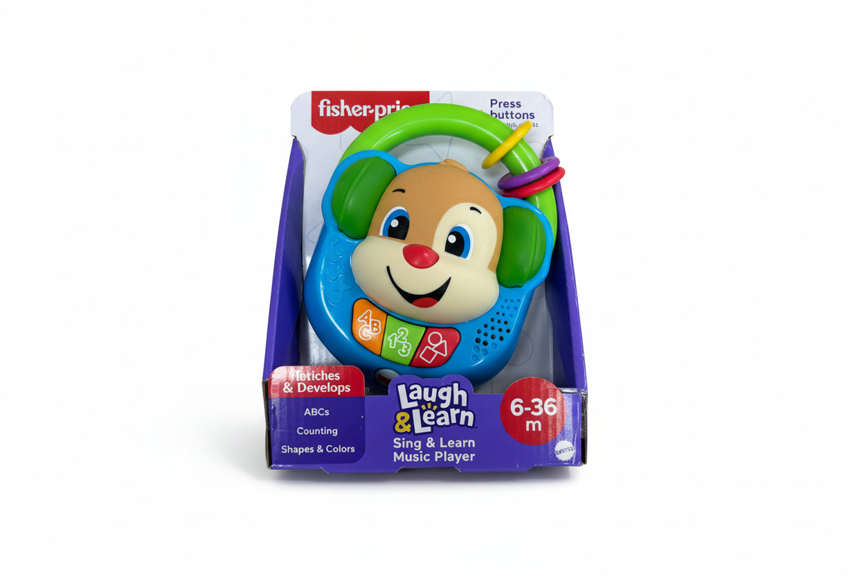 Fisher-Price laugh & learn toy in packaging on a wooden surface
